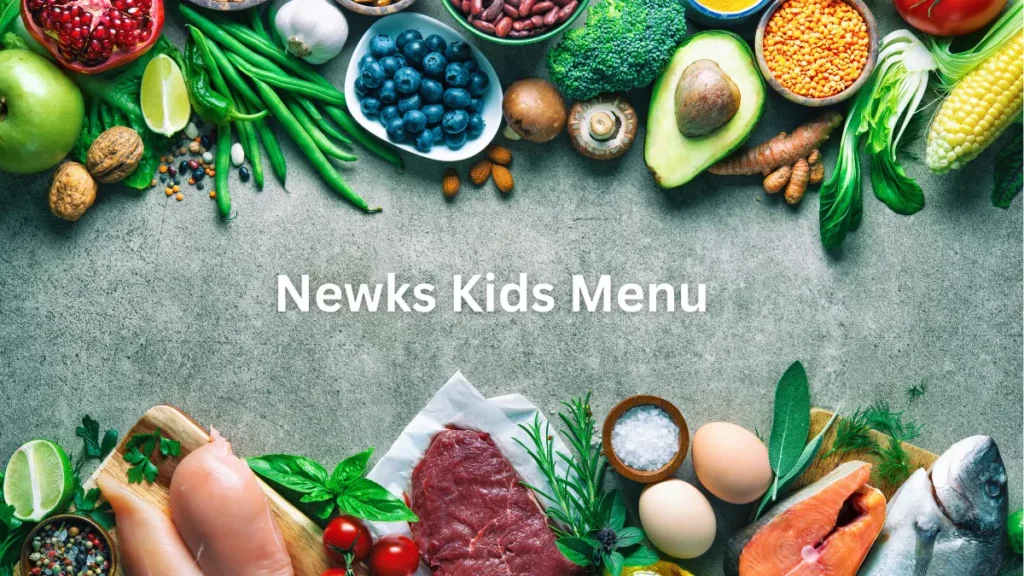 An assortment of fresh ingredients, including fruits, vegetables, meats, and grains, is artfully displayed around the text "Newks Kids Menu" on a gray surface.